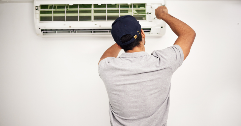 Man repairing an AC unit in Salt Lake City