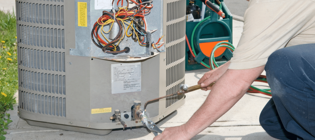 AC Not Keeping Up on 100°F Days in Salt Lake City? Here's Why 1 Air Conditioner Repair Utah technician checking AC system during Salt Lake City heat