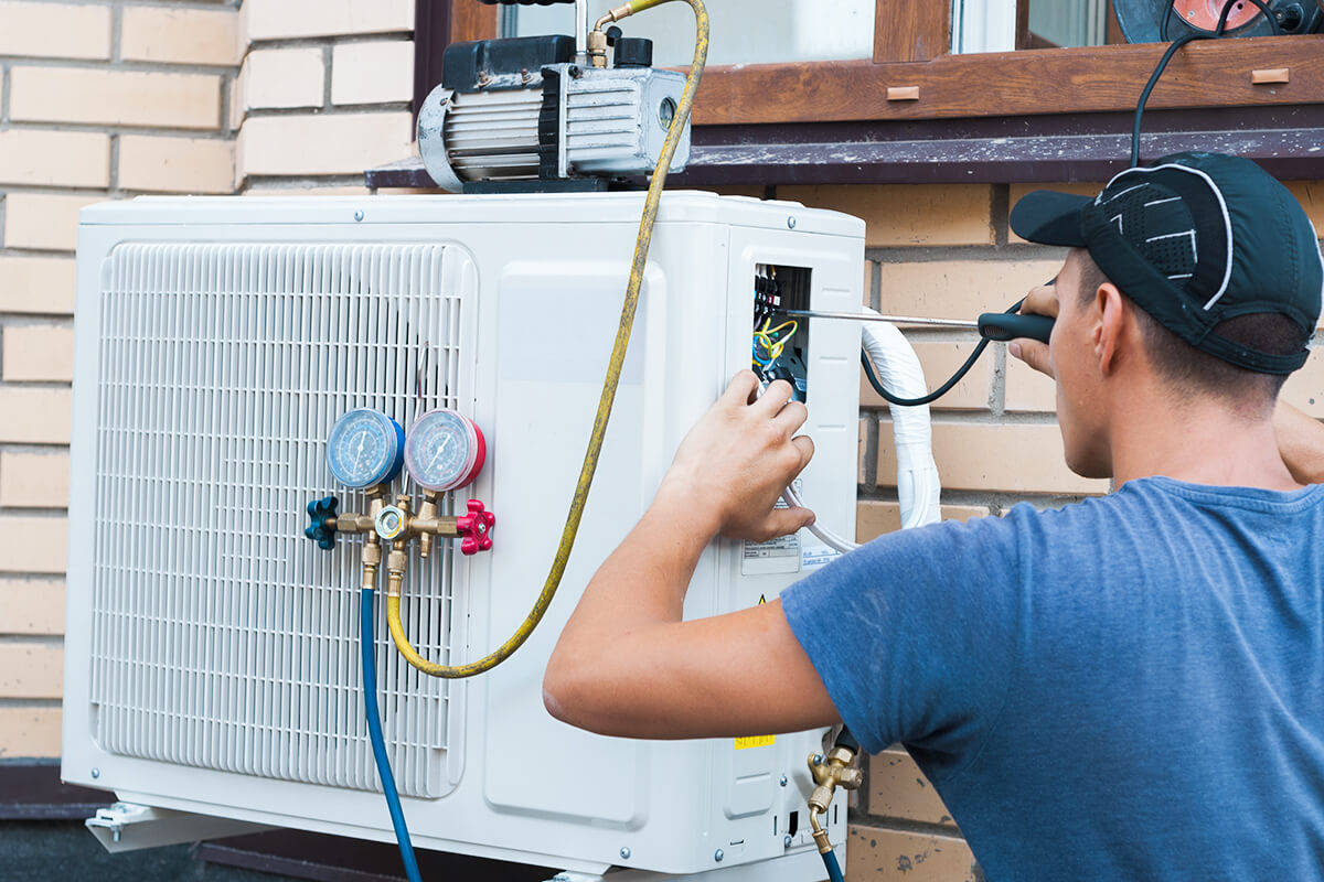 AC Not Keeping Up on 100°F Days in Salt Lake City? Here's Why 1 Air Conditioner Repair Utah technician checking AC system during Salt Lake City